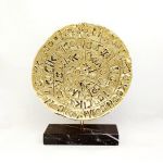 The disc of Phaistos. Handmade copy depicting both sides in gold-plated 24 K gold solution, based on black Greek marble.
