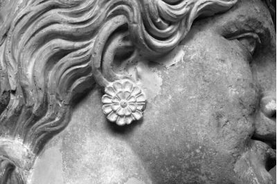 Marble caryatid wearing rosette earings, exhibit in the museum of Elefsis. European Capital of Culture 2023, Greece.