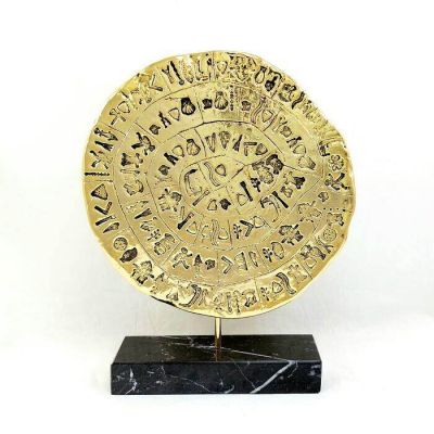 Phaistos disc gold-plated 24k copy on black Greek marble. Reverse side.
