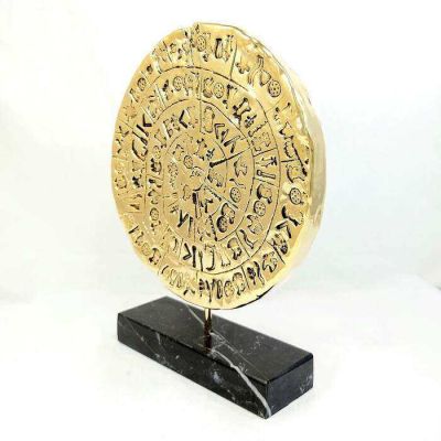 Phaistos disc gold-plated 24k copy on black Greek marble.